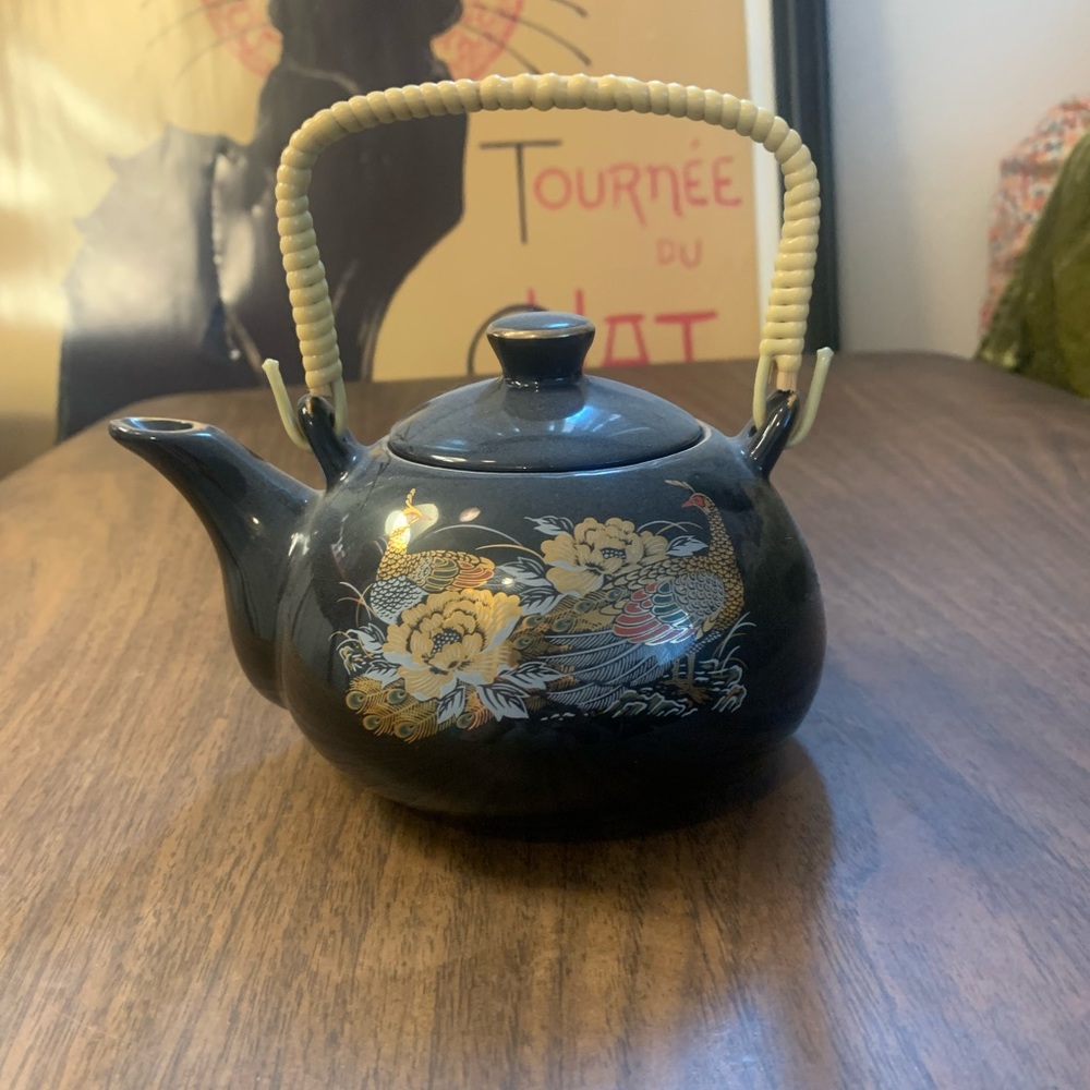Small black teapot with peacock design